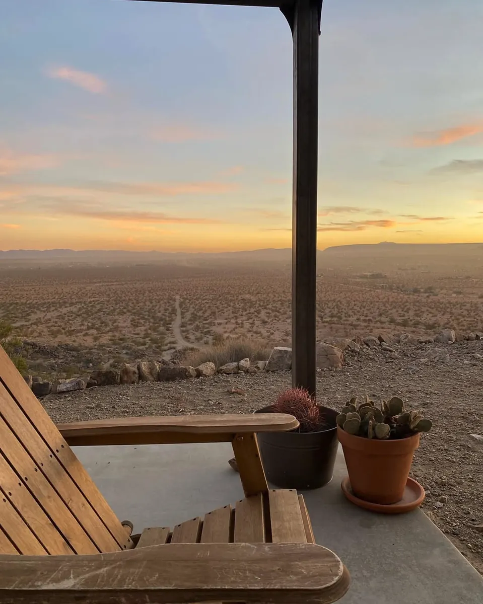 Wooden chair on the shaded porch at sunset