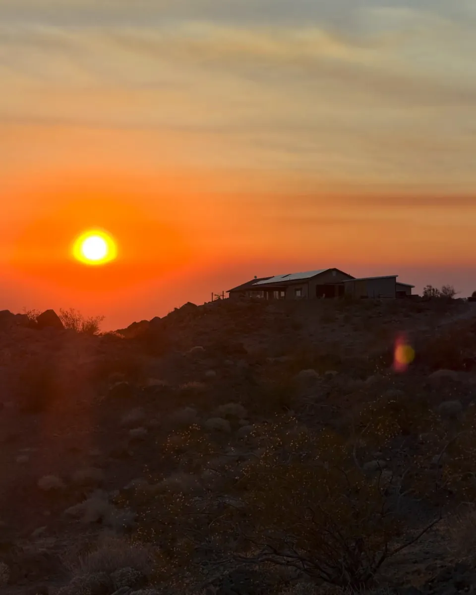 Sun setting over the ridge above the ranch