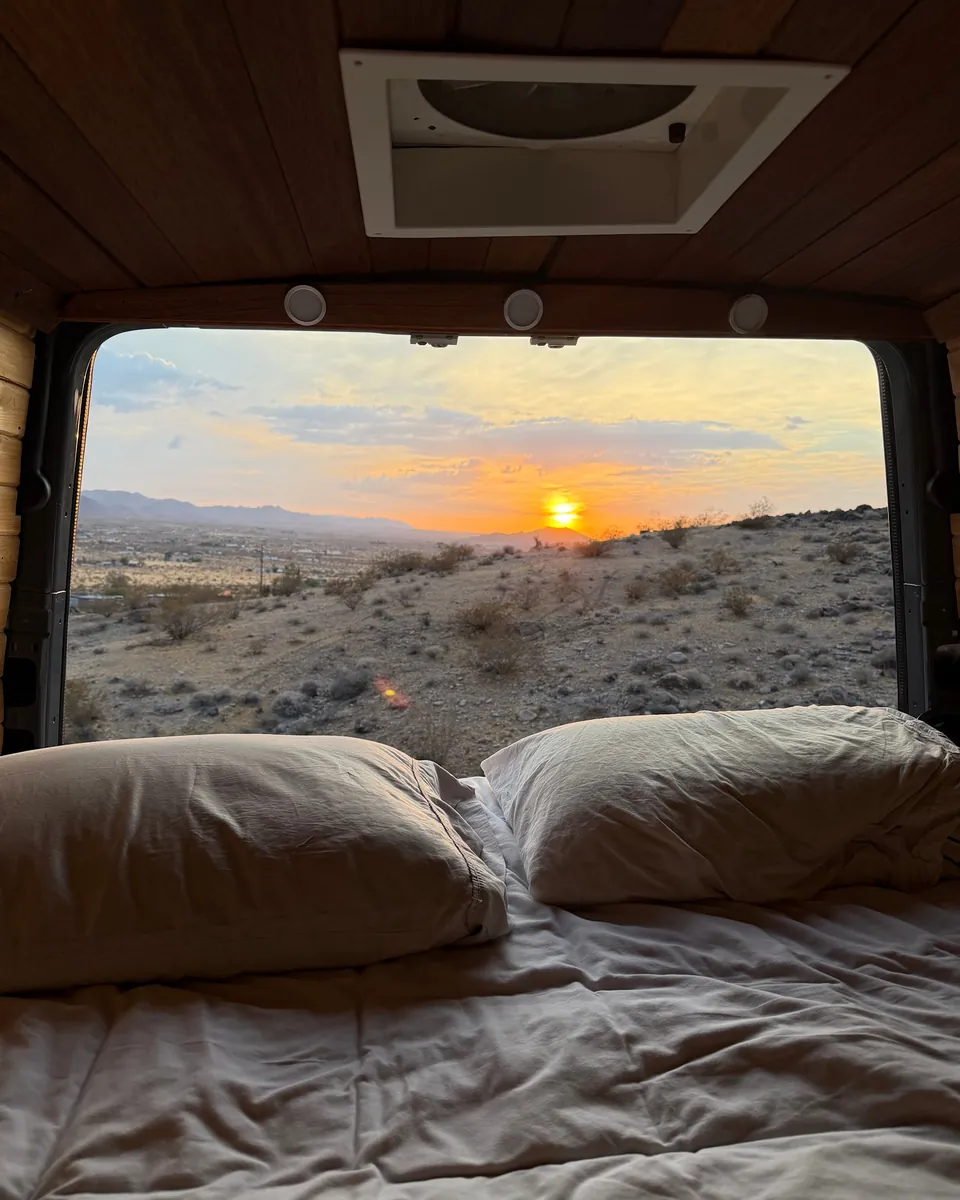 View of the desert sunrise through the back of the van